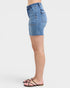 Denim shorts worn by a person on a white background