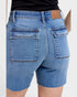 Blue denim shorts with a brown patch on a white background