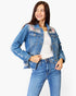 A woman wearing a light blue denim jacket with floral and leopard print embroidery on the shoulders, styled with blue jeans and a white top against a plain white background.