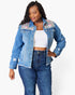 A woman modeling a light-wash blue denim jacket with colorful floral and leopard print embroidery on the shoulders, worn over a white crop top and dark blue jeans against a light gray background.
