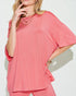 Person wearing a pink outfit with a plain background