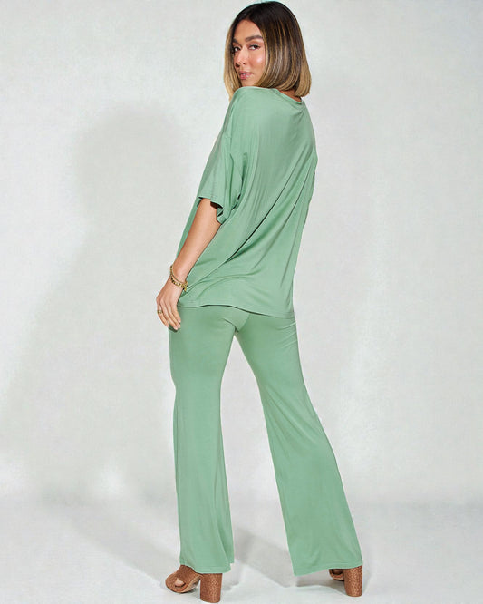 Woman wearing a green outfit on a white background