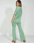 Woman wearing a green outfit on a white background