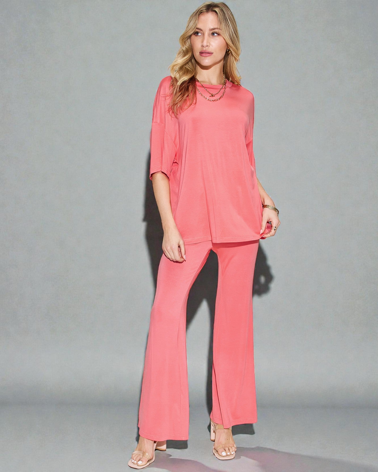 Woman wearing a pink outfit against a gray background