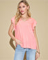 Woman wearing a pink top and blue jeans against a beige background