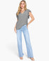 A woman modeling a heather gray short-sleeve top with ruffled shoulder details and light-wash blue flare jeans against a plain white studio background.