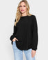 Woman wearing a black sweater and light blue jeans on a white background