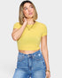 Woman wearing a yellow cropped top and blue jeans on a white background