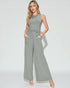 Woman wearing a gray ribbed jumpsuit on a white background