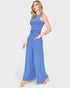 Woman wearing a blue ribbed jumpsuit on a white background