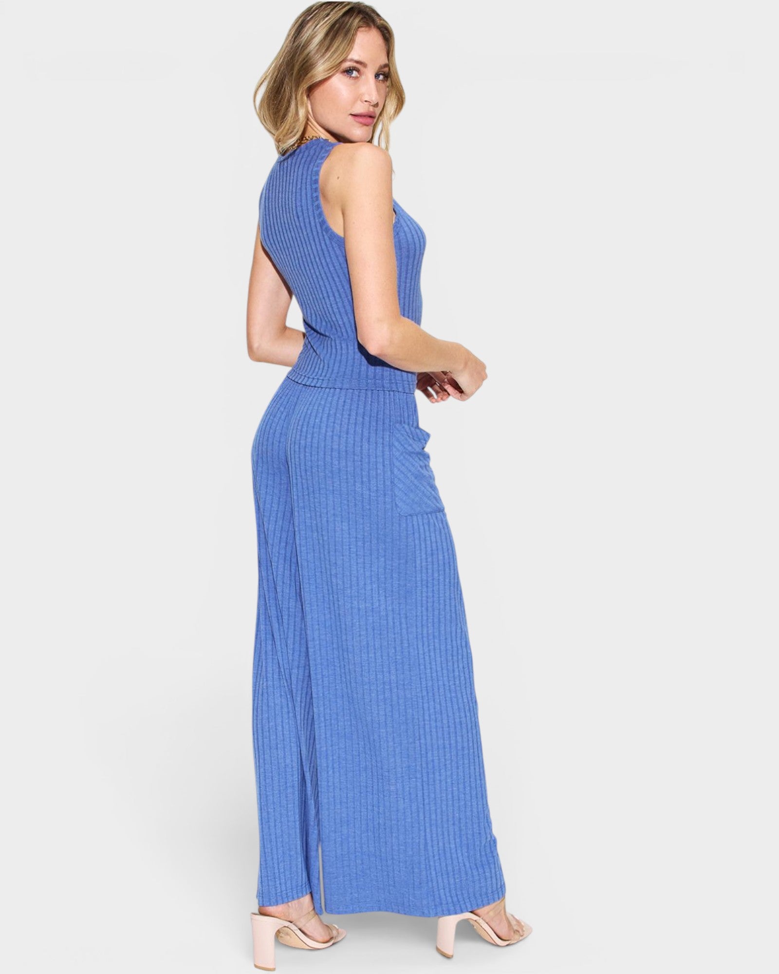 Woman wearing a blue sleeveless dress on a white background