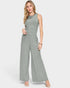 Woman wearing a green ribbed jumpsuit on a white background