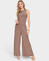 Woman wearing a brown ribbed jumpsuit on a white background