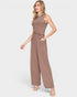 Woman wearing a brown ribbed jumpsuit on a white background