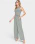 Woman wearing a green ribbed jumpsuit on a white background