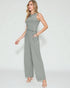 Woman wearing a gray ribbed jumpsuit on a white background