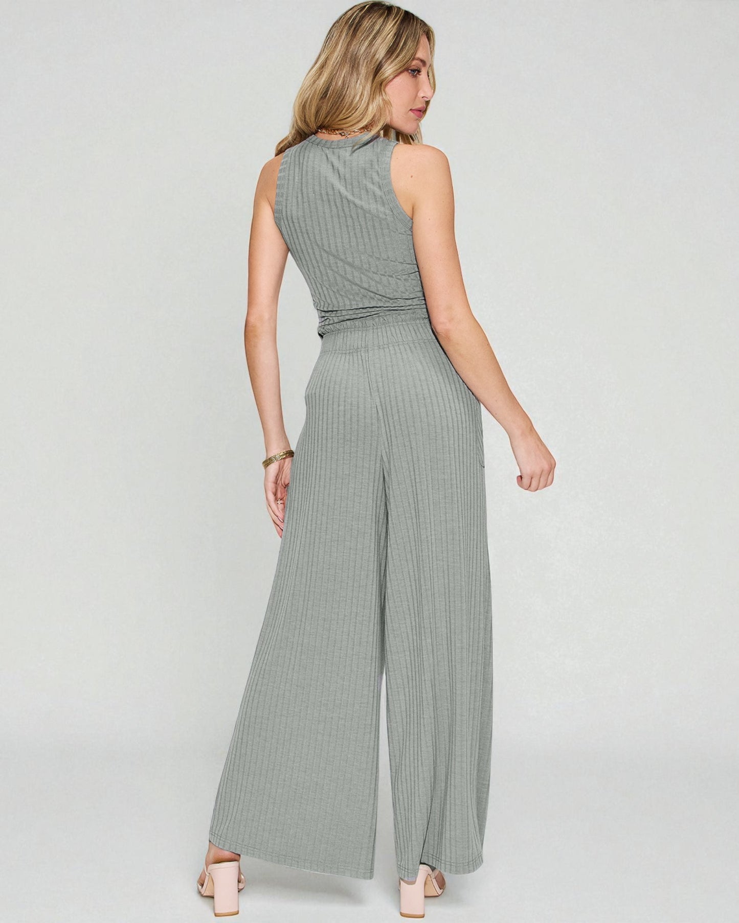 Woman wearing a gray jumpsuit on a white background