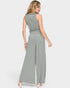 Woman wearing a green ribbed jumpsuit on a white background