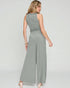 Woman wearing a gray jumpsuit on a white background
