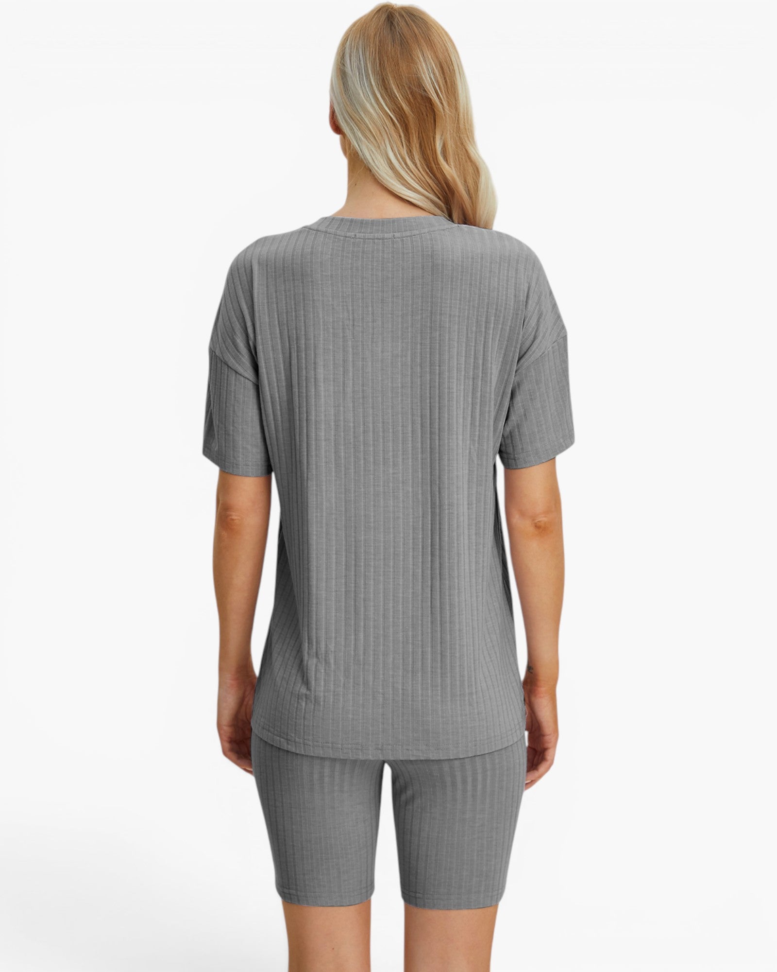 A woman shown from the back wearing a gray short-sleeve ribbed top and matching gray ribbed shorts against a plain white studio background.
