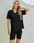 Woman wearing a black outfit with a plain background