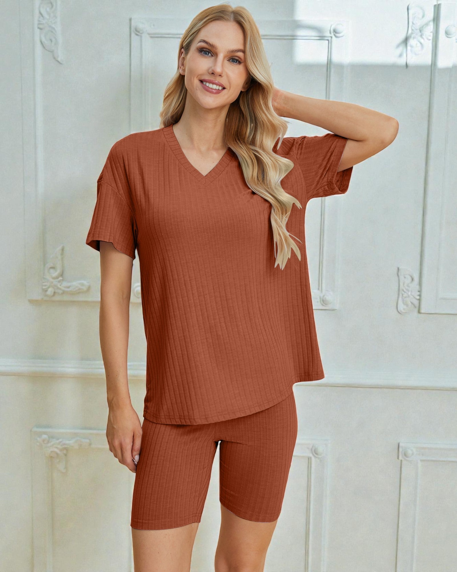 Woman wearing a brown ribbed pajama set in a bathroom setting