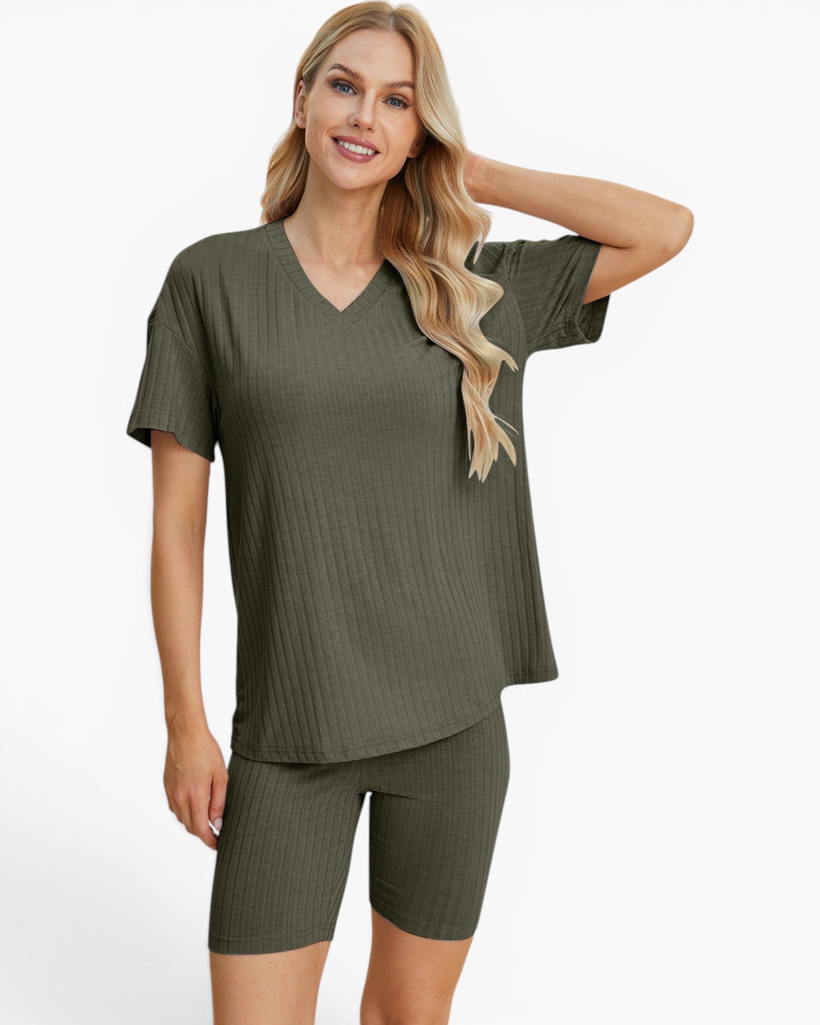 A woman modeling a matching ribbed two-piece loungewear set in olive green, featuring a short-sleeve V-neck top and fitted biker shorts, against a plain light gray studio background.