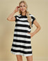 Woman wearing a black and white striped dress against a beige background