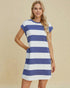 Woman wearing a blue and white striped dress on a beige background