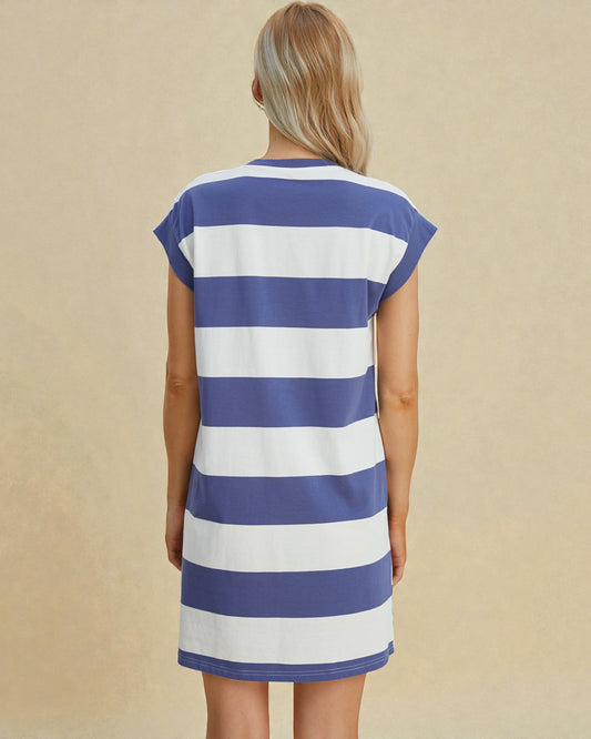 Woman wearing a blue and white striped dress against a beige background