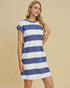 Woman wearing a blue and white striped dress against a beige background