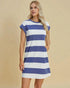 Woman wearing a blue and white striped dress against a beige background