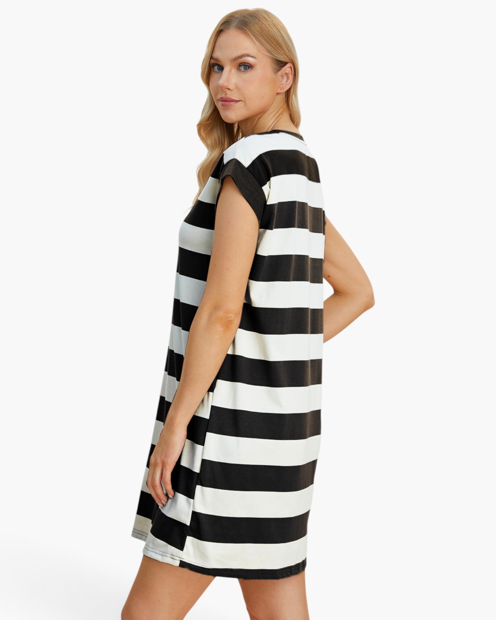 A woman modeling a sleeveless, A-line shift dress with bold horizontal black and white stripes, photographed against a clean white studio background.