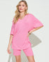 Woman wearing a pink outfit on a white background