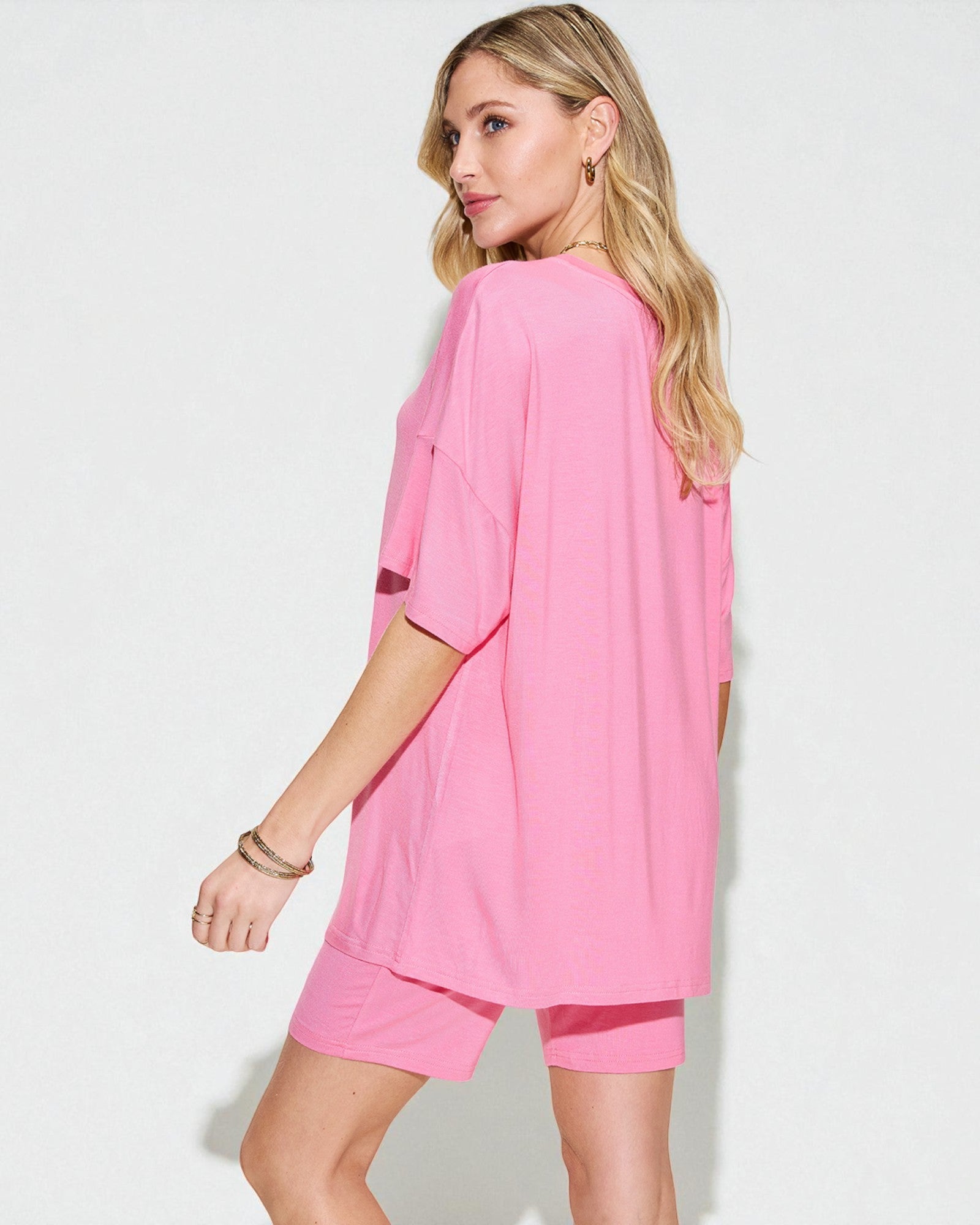 Woman wearing a pink outfit on a white background