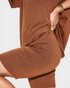 Brown dress with a close-up of the fabric on a white background