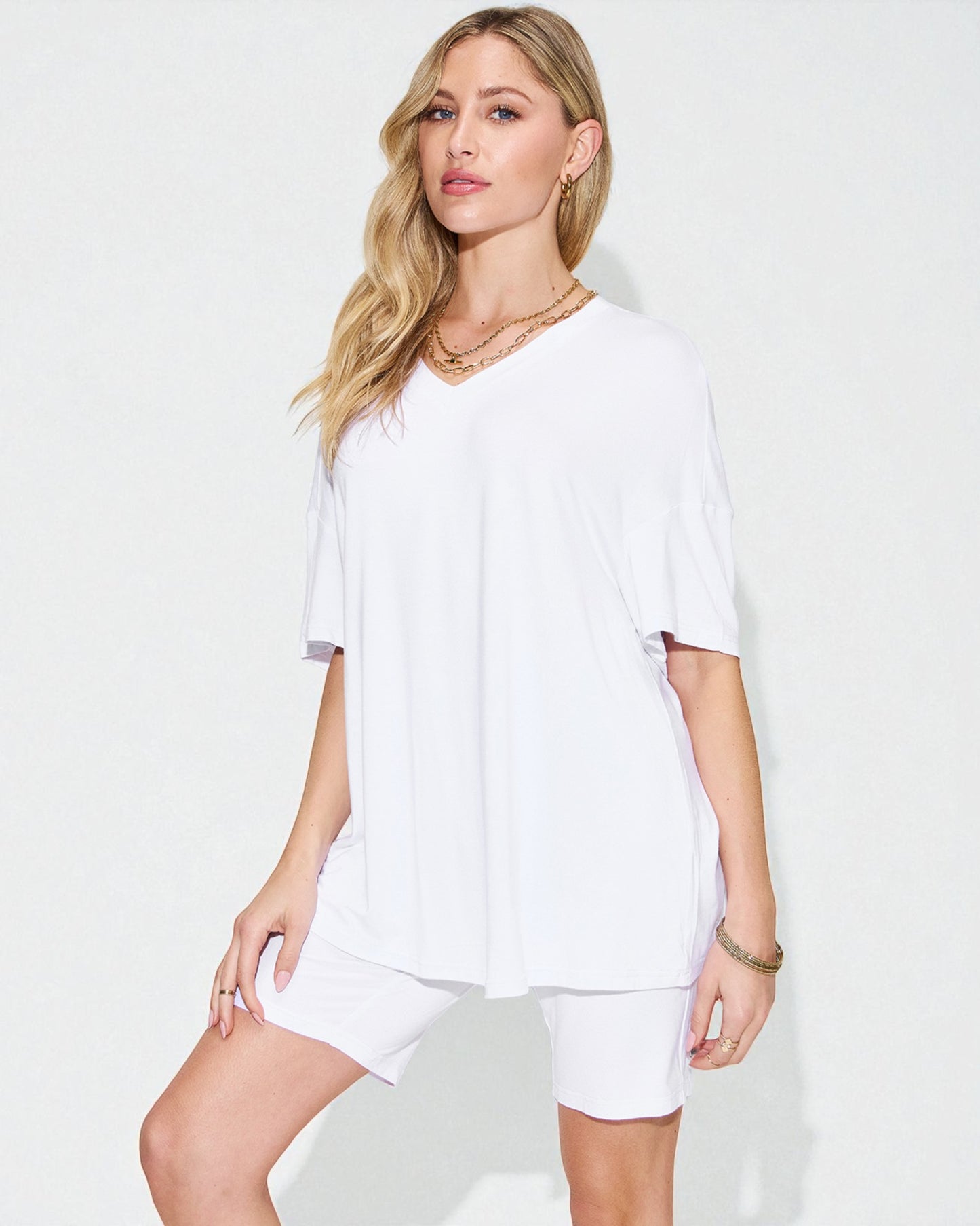 Woman wearing a white outfit on a plain background