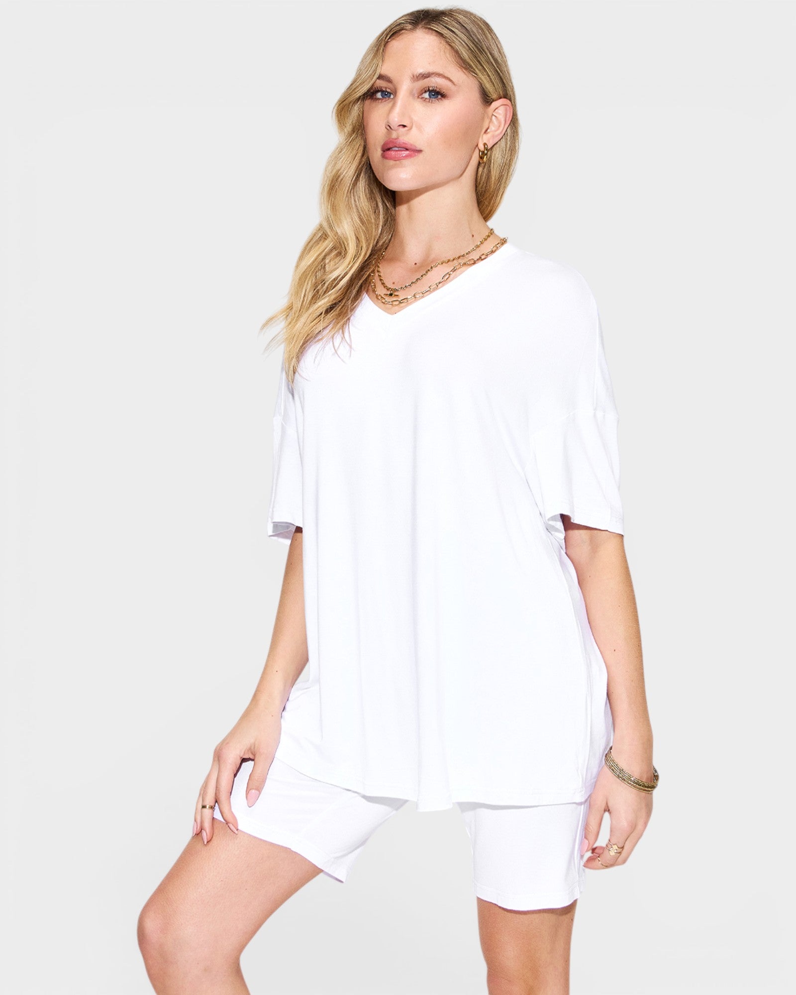 Woman wearing a white outfit on a plain background