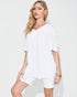 Woman wearing a white outfit on a plain background