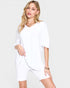 Woman wearing a white dress against a white background