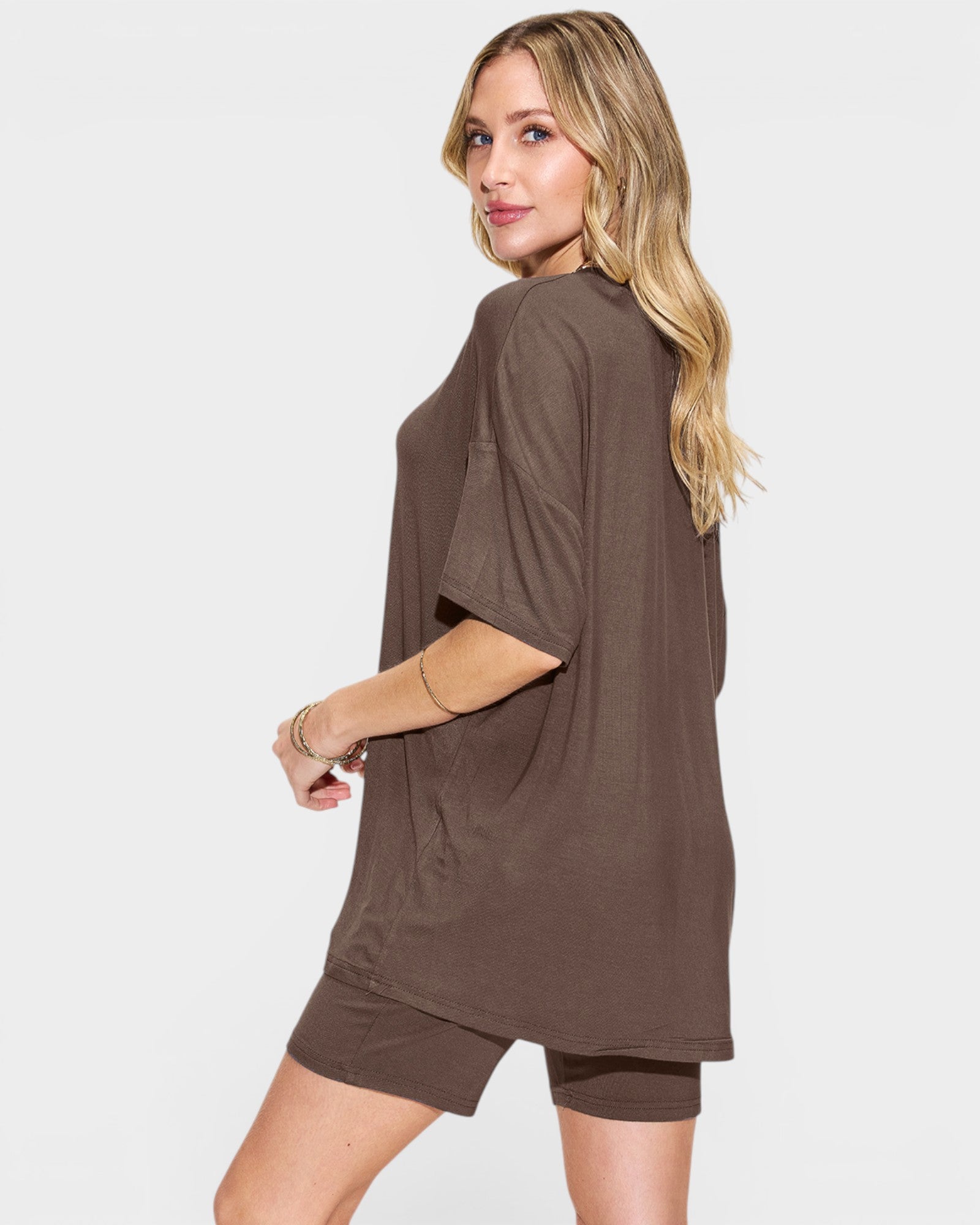 Woman wearing a brown dress with a plain background