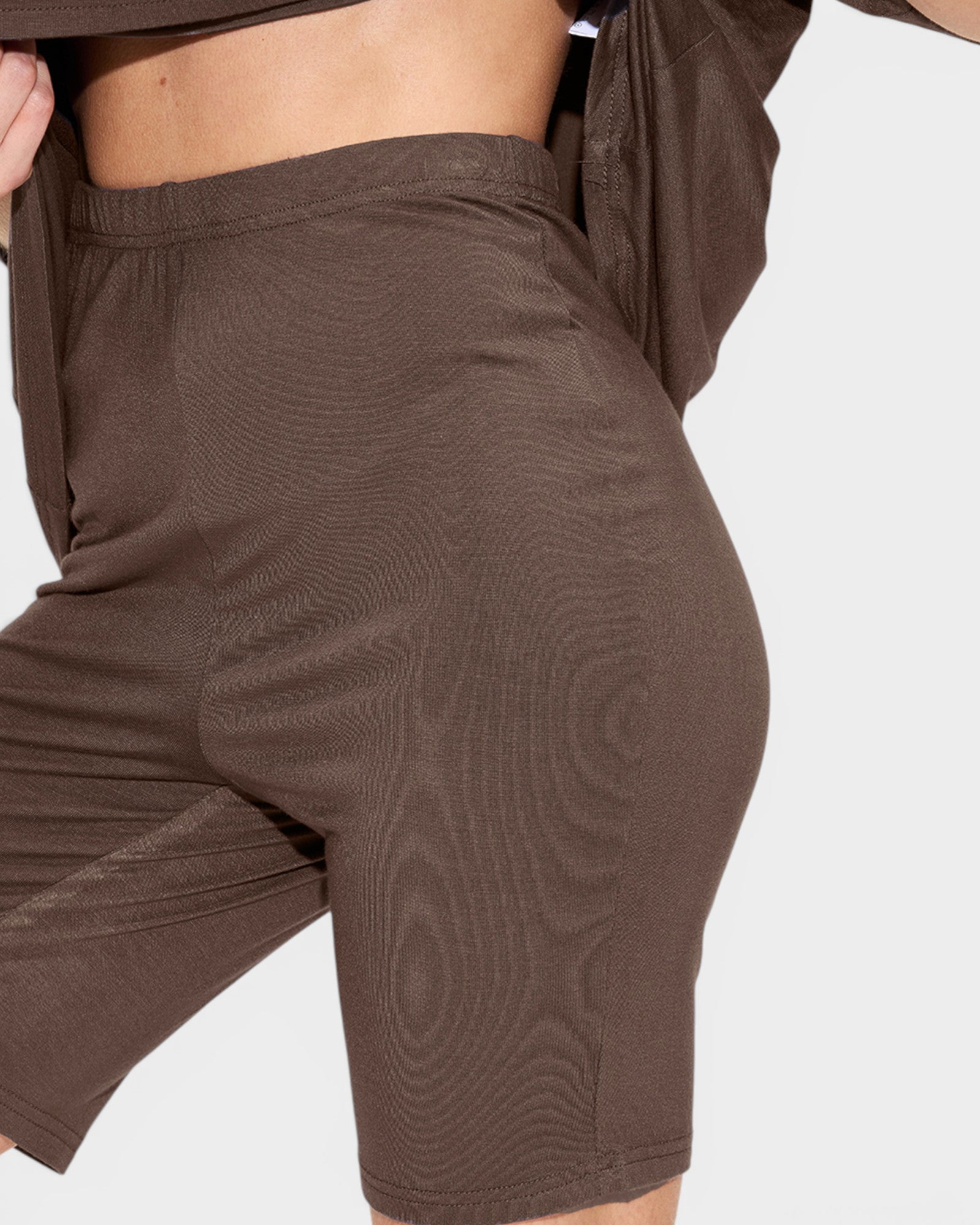 Brown shorts with a subtle pattern on a white background