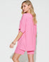 Woman wearing a pink outfit on a white background