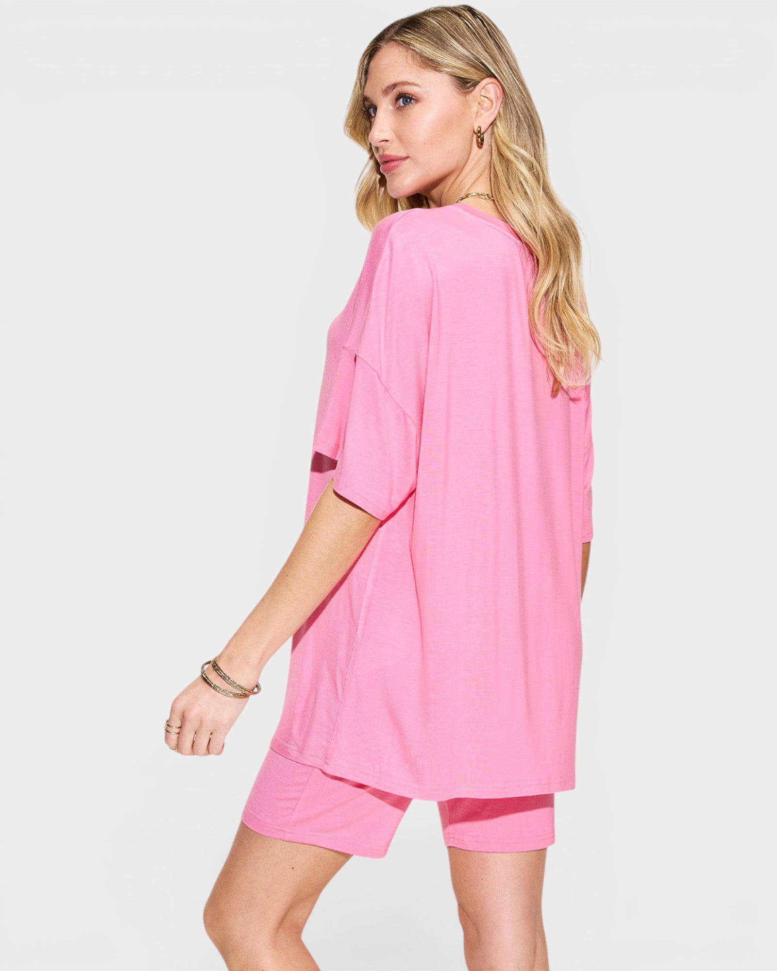 Woman wearing a pink outfit on a white background