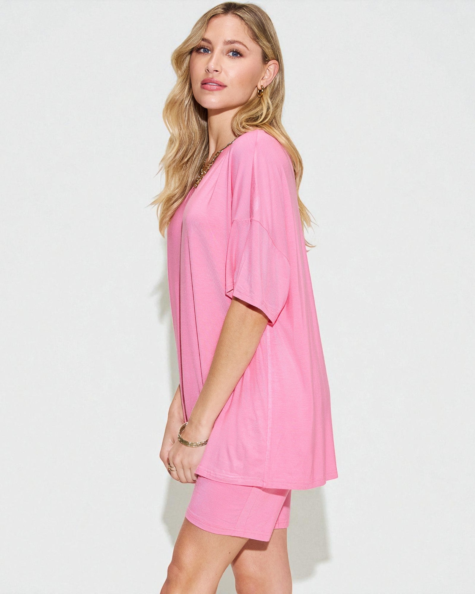 Woman wearing a pink outfit on a white background