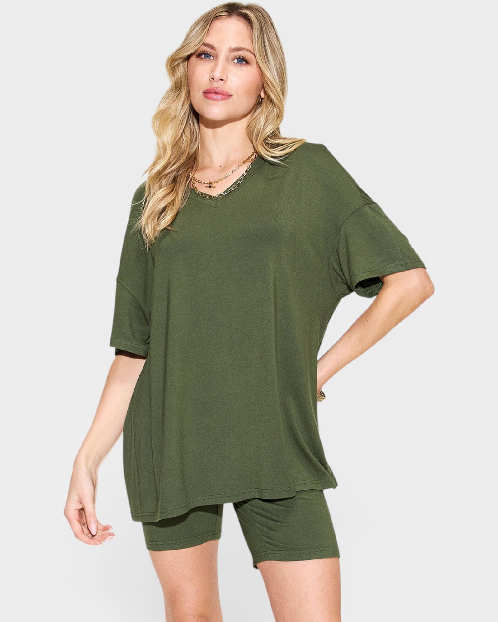 Woman wearing an olive green outfit on a white background