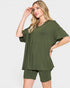 Woman wearing an olive green outfit on a white background