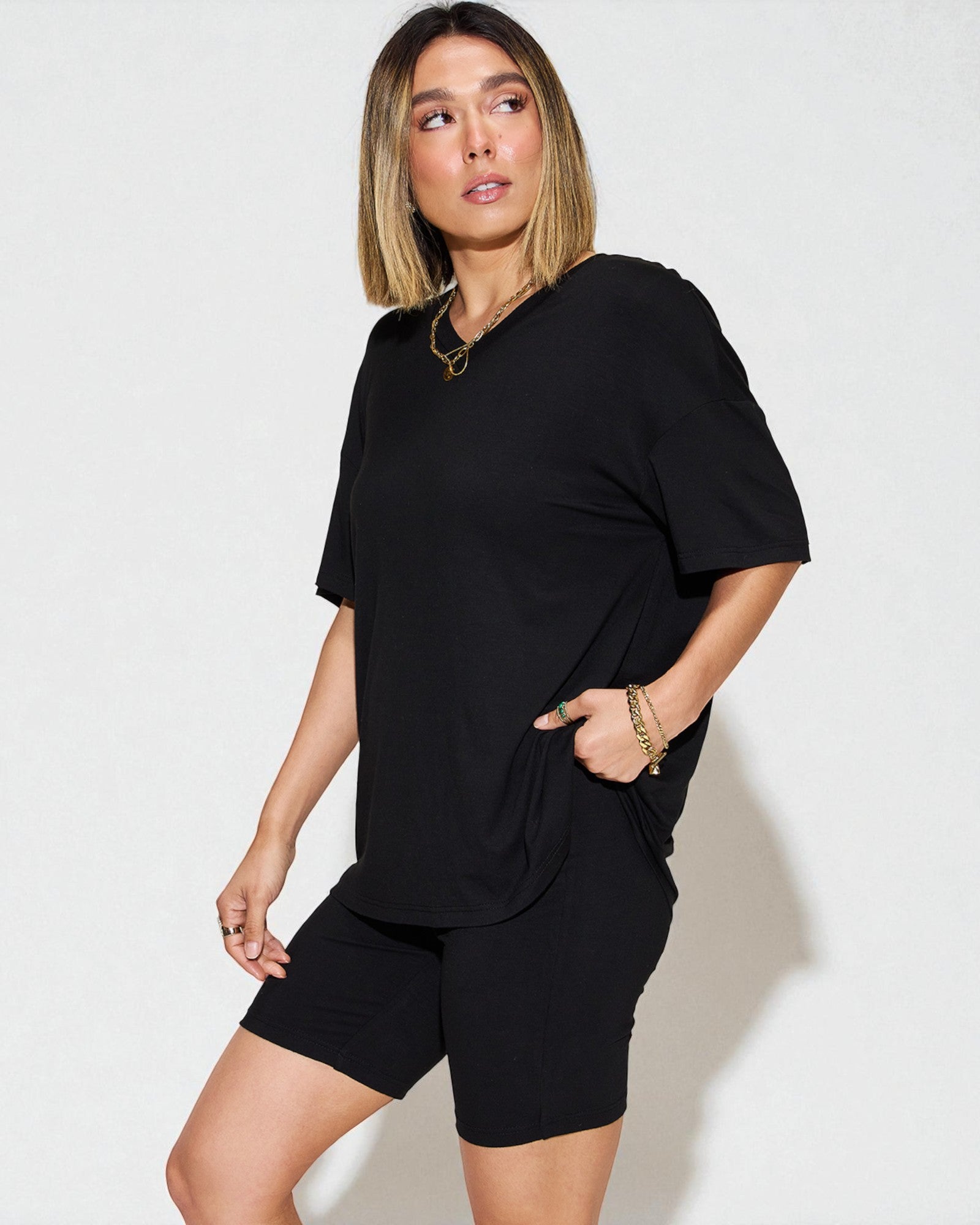 Woman wearing a black outfit on a white background