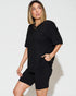 Woman wearing a black outfit on a white background