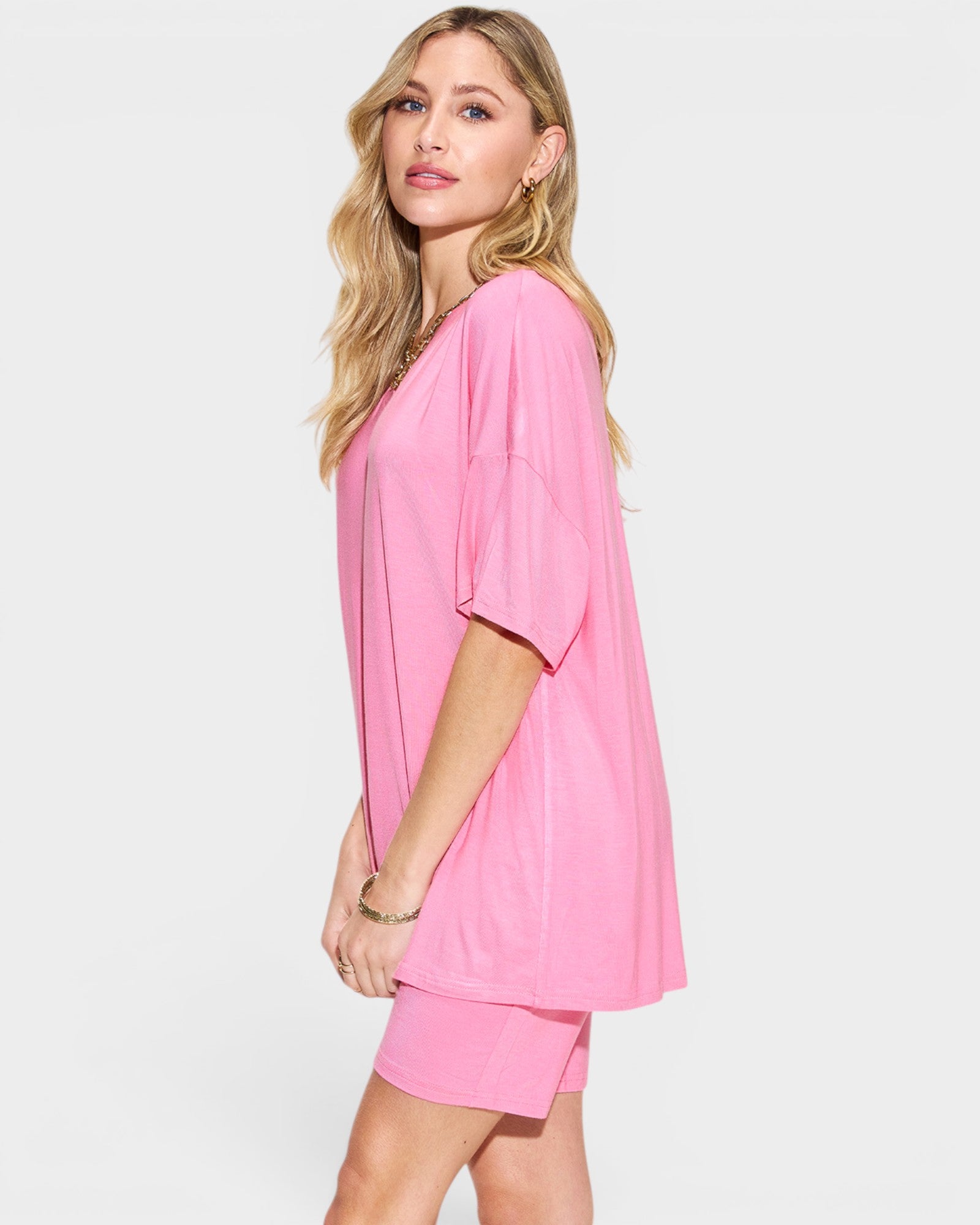 Woman wearing a pink outfit on a white background